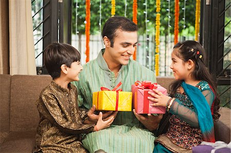 south asian - Children giving gifts to their father on Diwali Stock Photo - Premium Royalty-Free, Code: 630-07071982