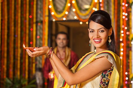 Woman holding an oil lamp on Diwali Stock Photo - Premium Royalty-Free, Code: 630-07072007