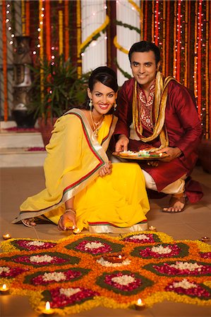 Couple decorating rangoli with oil lamps on Diwali Foto de stock - Sin royalties Premium, Código: 630-07072009