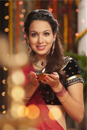 Woman holding an oil lamp on Diwali Stock Photo - Premium Royalty-Free, Code: 630-07072056