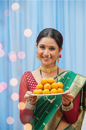 simsearch:655-03457904,k - Maharashtrian woman holding a plate of laddoo at Ganesh Chaturthi Stock Photo - Premium Royalty-Free, Code: 630-07072073