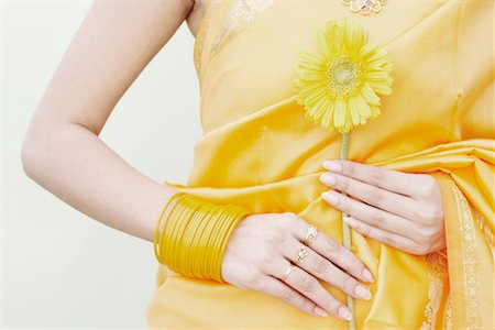 pic of one sunflower and stem - Mid section view of a young woman holding a flower Stock Photo - Premium Royalty-Free, Code: 630-01075566