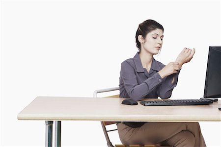 Businesswoman adjusting her cuff link Stock Photo - Premium Royalty-Free, Code: 630-01075718