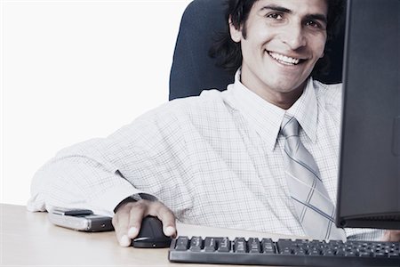 Portrait of a businessman using a computer Stock Photo - Premium Royalty-Free, Code: 630-01075737