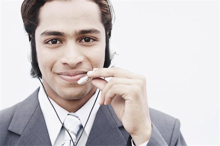 Portrait of a businessman wearing a headset Stock Photo - Premium Royalty-Free, Code: 630-01075798