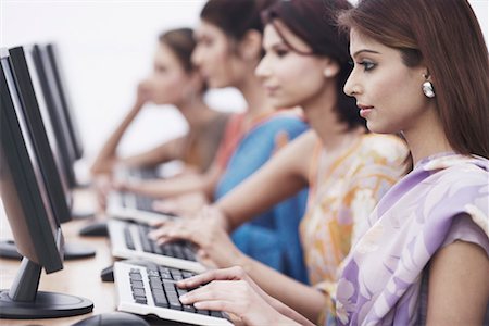 simsearch:630-01076251,k - Side profile of a businesswoman sitting in front of a computer Stock Photo - Premium Royalty-Free, Code: 630-01075822