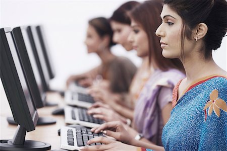 saree and hair bun - Close-up of four businesswomen sitting in front of computers Stock Photo - Premium Royalty-Free, Code: 630-01075839