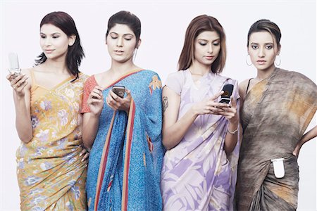 saree and hair bun - Close-up of four young women holding mobile phones Stock Photo - Premium Royalty-Free, Code: 630-01075871