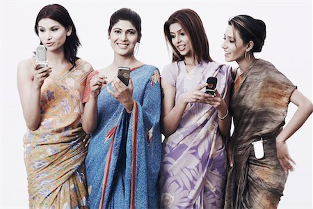 saree and hair bun - Close-up of four young women holding mobile phones Stock Photo - Premium Royalty-Free, Code: 630-01075872