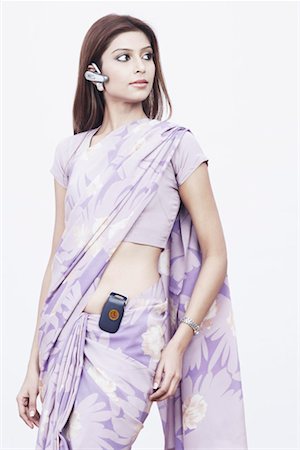 saree style - Close-up of a young woman wearing a hands free device Stock Photo - Premium Royalty-Free, Code: 630-01075882