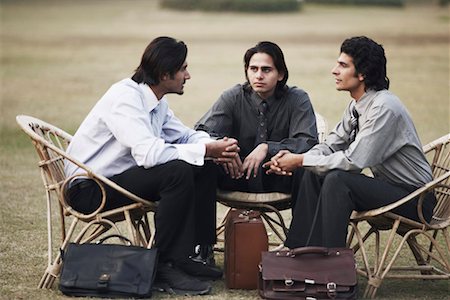 Three businessmen sitting on chairs Stock Photo - Premium Royalty-Free, Code: 630-01075940