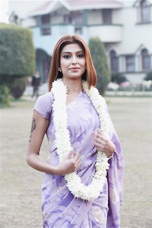 Portrait of a young woman wearing a garland Stock Photo - Premium Royalty-Free, Code: 630-01075961