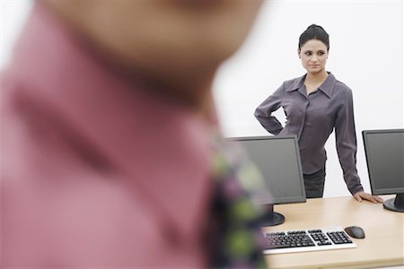 formal mouse computer - Businesswoman standing behind two computers Stock Photo - Premium Royalty-Free, Code: 630-01076087