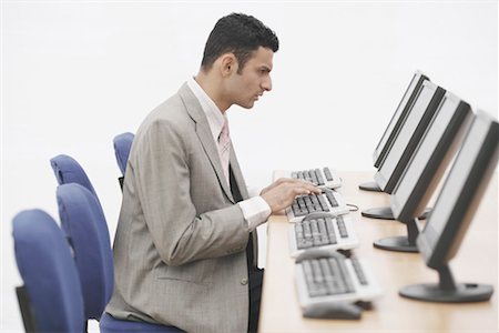 simsearch:630-01128454,k - Side profile of a businessman sitting in front of a computer Stock Photo - Premium Royalty-Free, Code: 630-01076250