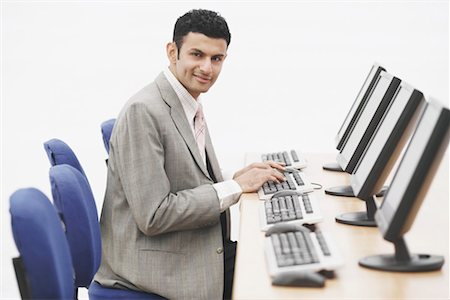 simsearch:630-01128454,k - Portrait of a businessman sitting in front of a computer Stock Photo - Premium Royalty-Free, Code: 630-01076251