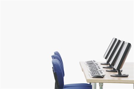 Computer on a table in front of chairs Stock Photo - Premium Royalty-Free, Code: 630-01076272