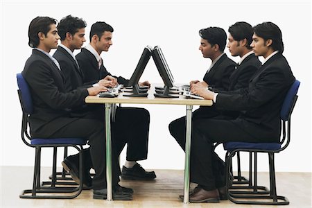 simsearch:630-01076251,k - Side profile of a group of businessmen working on computers in an office Stock Photo - Premium Royalty-Free, Code: 630-01076287