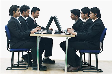 simsearch:630-01076251,k - Side profile of a group of businessmen working on computers in an office Stock Photo - Premium Royalty-Free, Code: 630-01076288