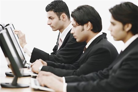 simsearch:630-01076251,k - Side profile of three businessmen working on computers in an office Stock Photo - Premium Royalty-Free, Code: 630-01076295