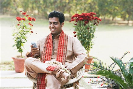 simsearch:655-03457904,k - Close-up of a young man operating a mobile phone Stock Photo - Premium Royalty-Free, Code: 630-01076446