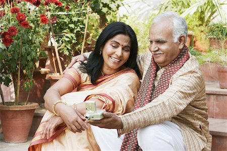 Close-up of a mature couple looking at a digital camera Stock Photo - Premium Royalty-Free, Code: 630-01076460