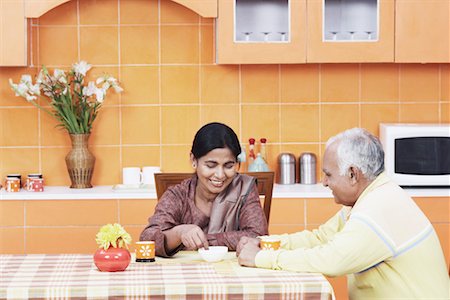 simsearch:655-03457904,k - Mature couple having tea at the dining table Stock Photo - Premium Royalty-Free, Code: 630-01076540