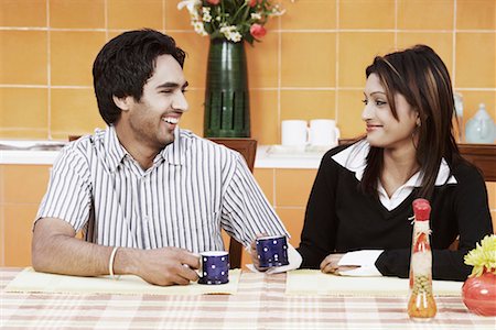 Young couple having tea at the dining table Stock Photo - Premium Royalty-Free, Code: 630-01076543