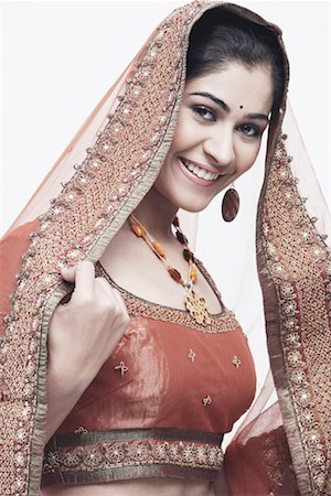 female and earring glamour head and shoulders - Portrait of a young woman in traditional clothing smiling Stock Photo - Premium Royalty-Free, Code: 630-01076868