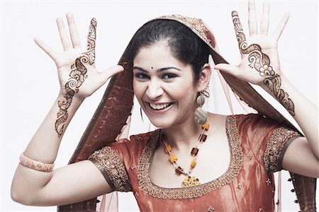 Portrait of a young woman with henna tattoo's on her hands Stock Photo - Premium Royalty-Free, Code: 630-01076945