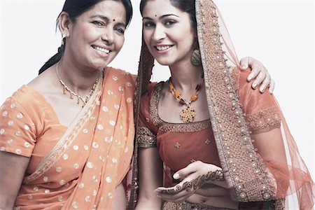 saree and hair bun - Portrait of a mother and her daughter smiling Stock Photo - Premium Royalty-Free, Code: 630-01076951