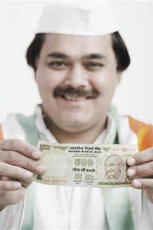 politician kurta and cap - Portrait of a mature man holding Indian currency Stock Photo - Premium Royalty-Free, Code: 630-01077107