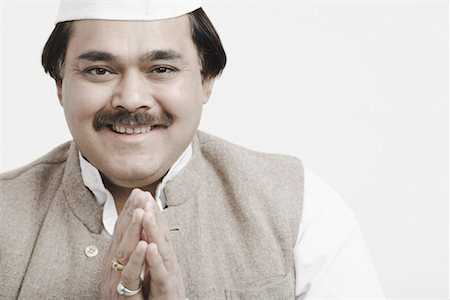 politician kurta and cap - Portrait of a male politician greeting Stock Photo - Premium Royalty-Free, Code: 630-01077100