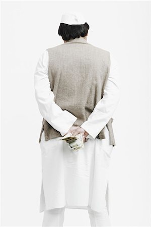 politician - Rear view of a mature man holding Indian currency Stock Photo - Premium Royalty-Free, Code: 630-01077102