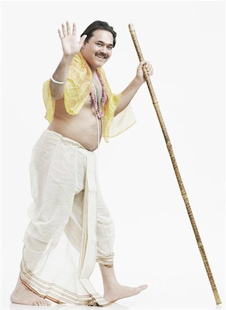 portrait 40s indian man one person - Portrait of a priest holding a stick Stock Photo - Premium Royalty-Free, Code: 630-01077159