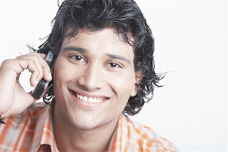 simsearch:630-01128257,k - Portrait of a young man talking on a mobile phone Stock Photo - Premium Royalty-Free, Code: 630-01077356