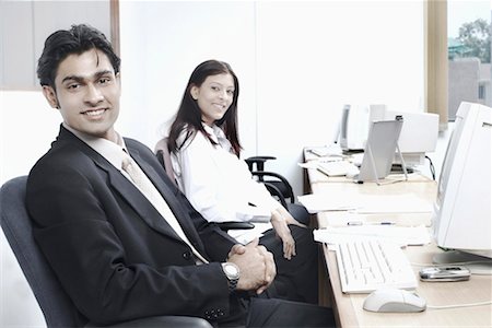 formal mouse computer - Portrait of a businessman and a businesswoman sitting in an office Stock Photo - Premium Royalty-Free, Code: 630-01077448