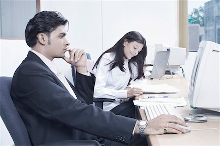 formal mouse computer - Businessman and a businesswoman sitting in an office Stock Photo - Premium Royalty-Free, Code: 630-01077449