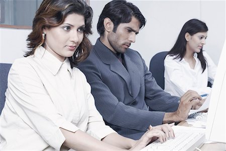 formal mouse computer - Two businesswomen and a businessman in an office Stock Photo - Premium Royalty-Free, Code: 630-01077453
