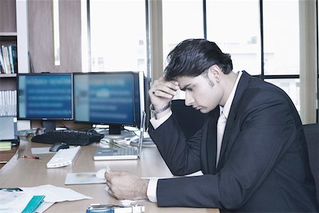 simsearch:630-01076251,k - Side profile of a businessman sitting in an office Stock Photo - Premium Royalty-Free, Code: 630-01077482