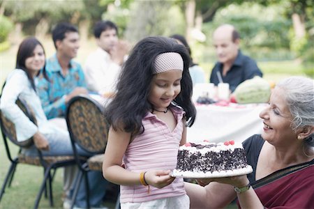 Mature woman and a girl holding a cake Stock Photo - Premium Royalty-Free, Code: 630-01077961