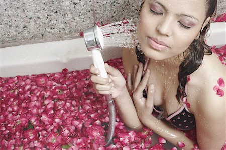 High angle view of a young woman holding a shower Stock Photo - Premium Royalty-Free, Code: 630-01078238