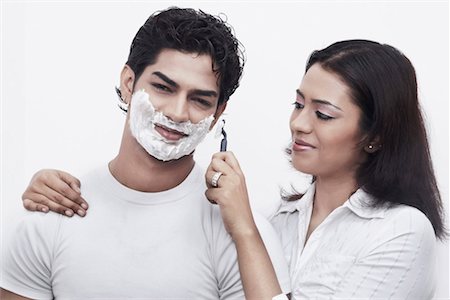 shaving man woman - Close-up of a young woman shaving a young man Stock Photo - Premium Royalty-Free, Code: 630-01078527