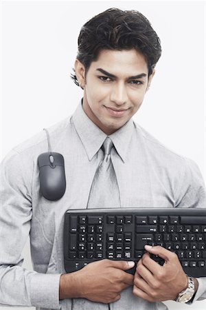 Portrait of a businessman holding a computer keyboard Stock Photo - Premium Royalty-Free, Code: 630-01078625