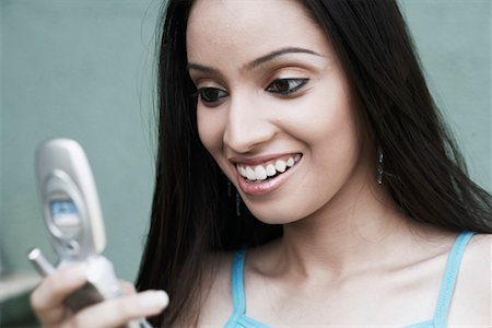 Close-up of a teenage girl holding a mobile phone Stock Photo - Premium Royalty-Free, Code: 630-01078922