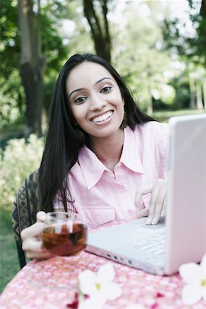 Portrait of a teenage girl using a laptop Stock Photo - Premium Royalty-Free, Code: 630-01079044