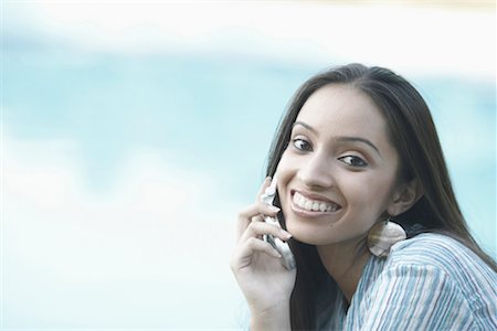 Portrait of a teenage girl talking on a mobile phone Stock Photo - Premium Royalty-Free, Code: 630-01079128