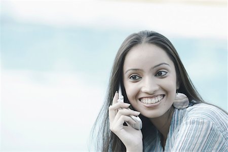 Close-up of a teenage girl talking on a mobile phone Stock Photo - Premium Royalty-Free, Code: 630-01079130