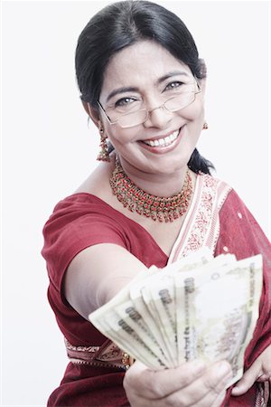 Portrait of a mature woman holding Indian five hundred rupee notes Stock Photo - Premium Royalty-Free, Code: 630-01079228