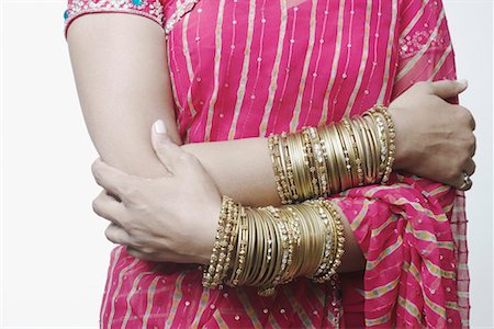 Mid section view of a woman wearing bangles Stock Photo - Premium Royalty-Free, Code: 630-01079485