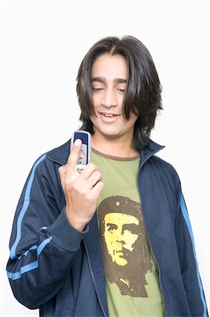 Close-up of a young man holding a mobile phone Stock Photo - Premium Royalty-Free, Code: 630-01079583